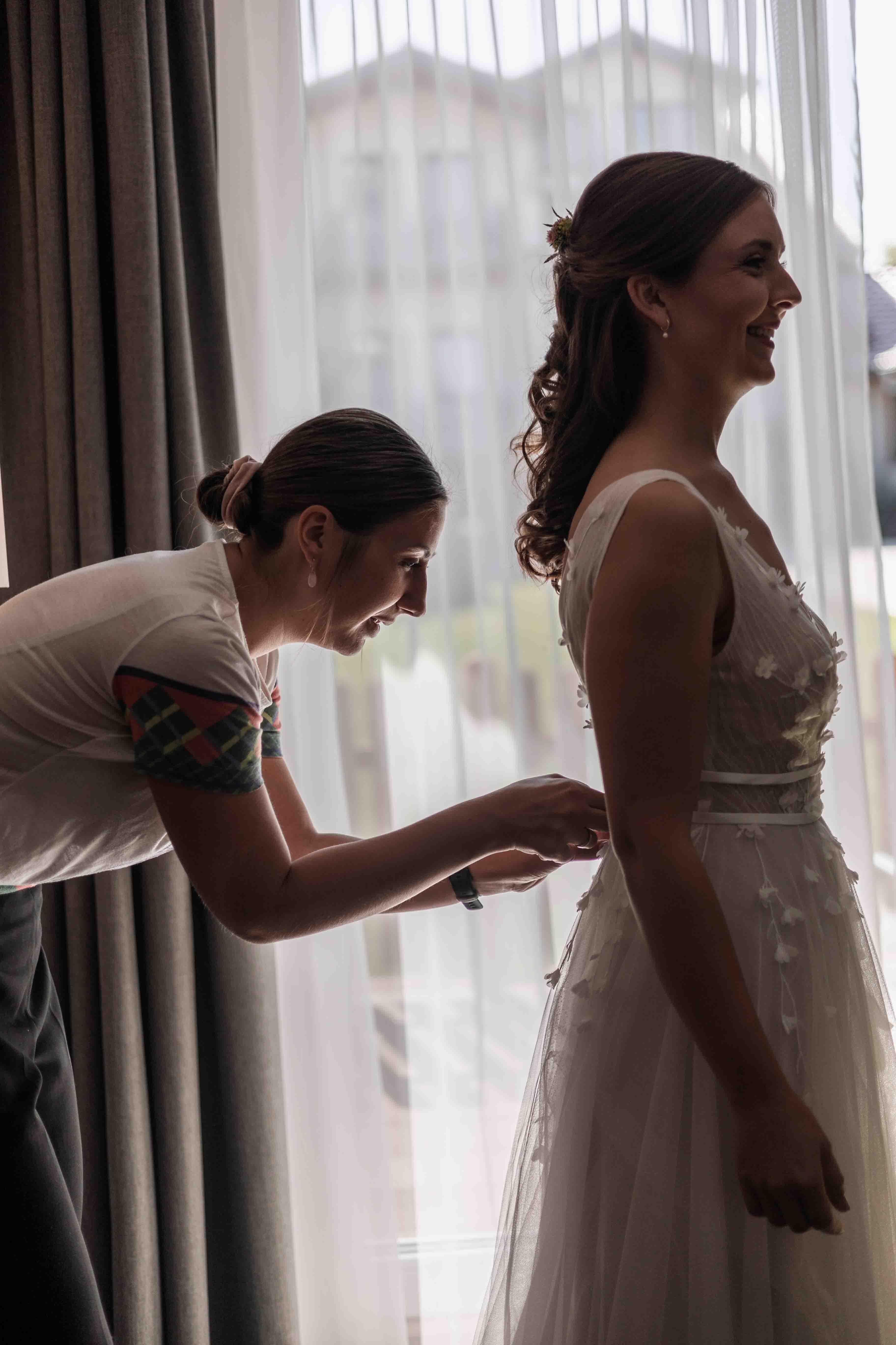 Hochzeitsfoto der Braut beim Getting-Ready und Ankleiden des Brautkleids