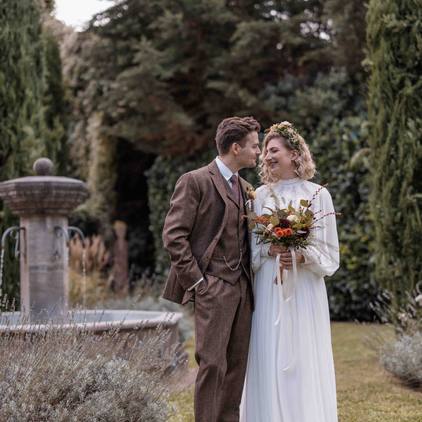 Hochzeitsfoto Braut und Bräutigam am Brunnen stehend